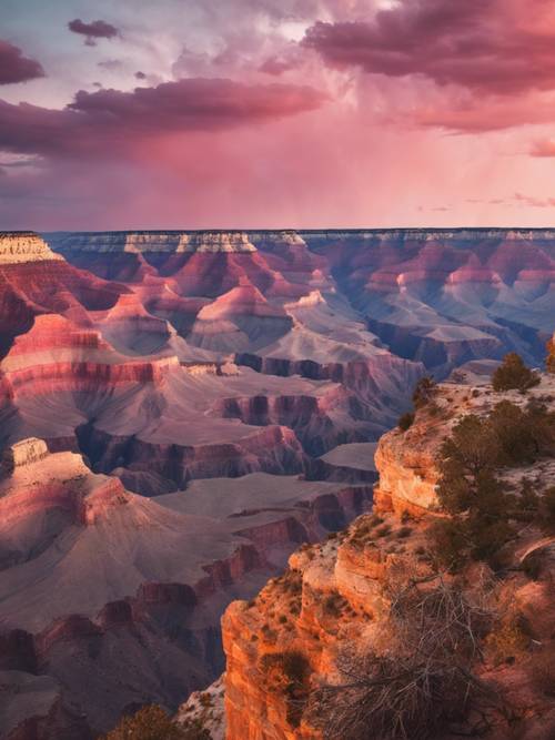 A pink and orange hued sunset over the Grand Canyon