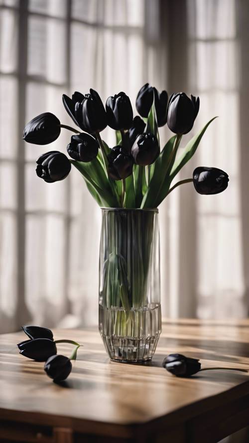 A bouquet of black tulips displayed in a crystal vase standing on a wooden table.