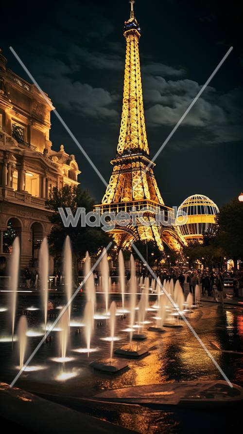 Wieża Eiffla świecąca w nocy z fontannami